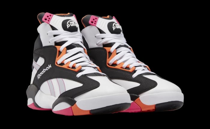 View of white, black, and orange Reebok sneakers.
